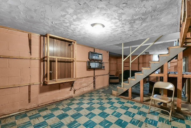 basement featuring a textured ceiling