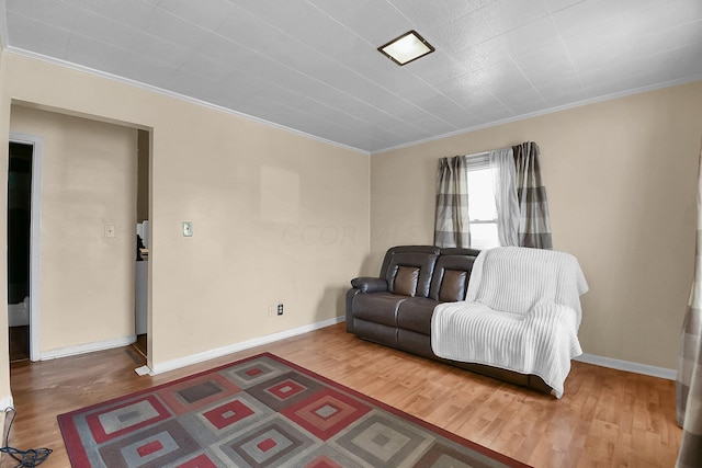 living room with hardwood / wood-style flooring and ornamental molding