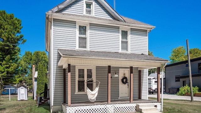 view of property featuring central AC unit and covered porch