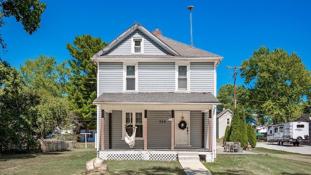 front of property with a porch and a front yard