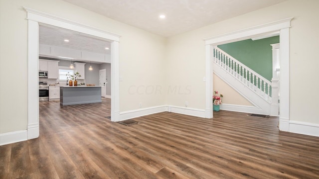 unfurnished room featuring dark hardwood / wood-style flooring