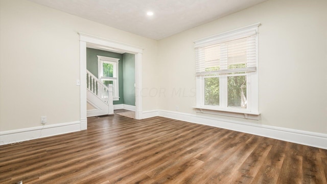 empty room with dark hardwood / wood-style floors