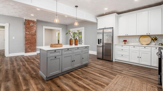 kitchen with white cabinetry, stainless steel fridge with ice dispenser, dark hardwood / wood-style flooring, and hanging light fixtures