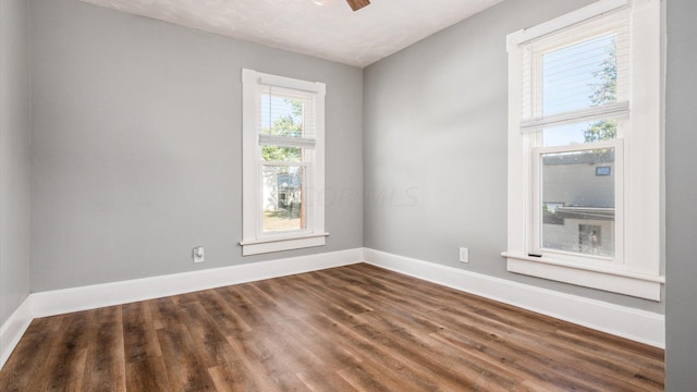 spare room featuring dark wood-type flooring