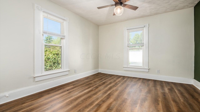 empty room featuring ceiling fan and dark hardwood / wood-style flooring