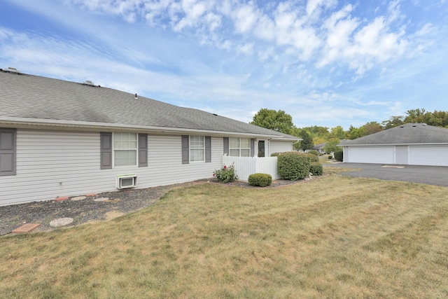 view of side of property featuring a lawn and a garage