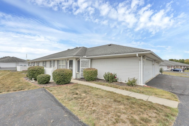 view of front of house with a garage and a front lawn