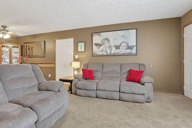 carpeted living room featuring ceiling fan