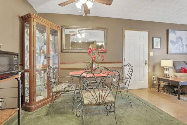 dining area featuring ceiling fan and wood-type flooring