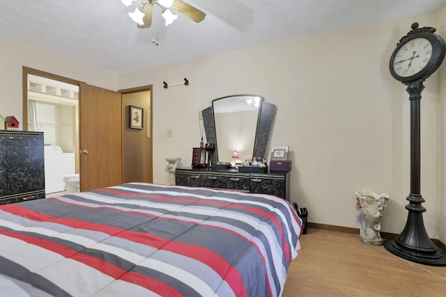 bedroom with washer / clothes dryer, ceiling fan, ensuite bath, and light wood-type flooring