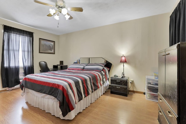 bedroom featuring light hardwood / wood-style flooring and ceiling fan