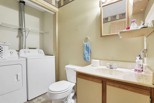 bathroom featuring vanity, toilet, and washing machine and clothes dryer