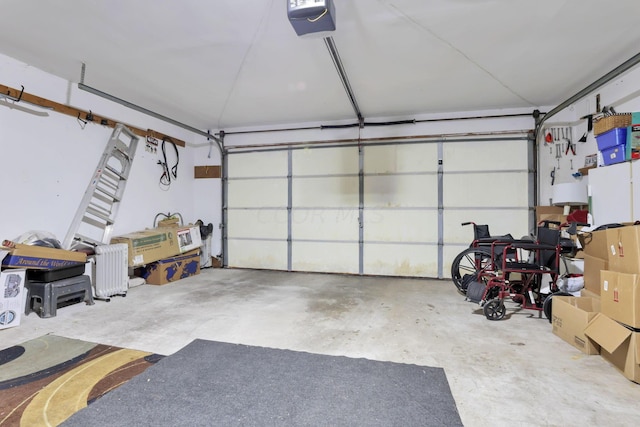 garage featuring radiator and a garage door opener