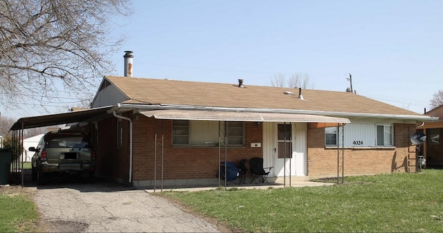 exterior space featuring a carport and a yard