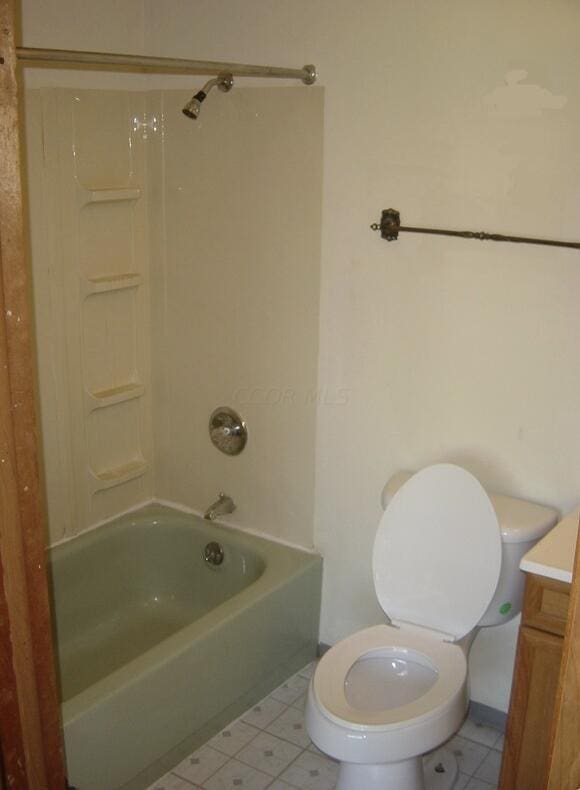 full bathroom with toilet, tile patterned flooring, vanity, and washtub / shower combination