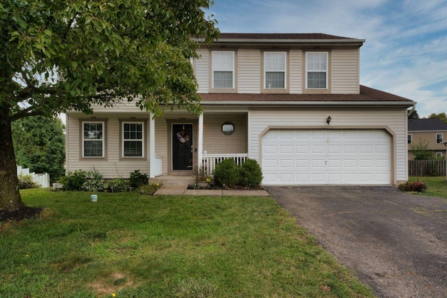 view of front of home with a garage, a porch, and a front lawn