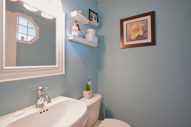 bathroom featuring sink and toilet