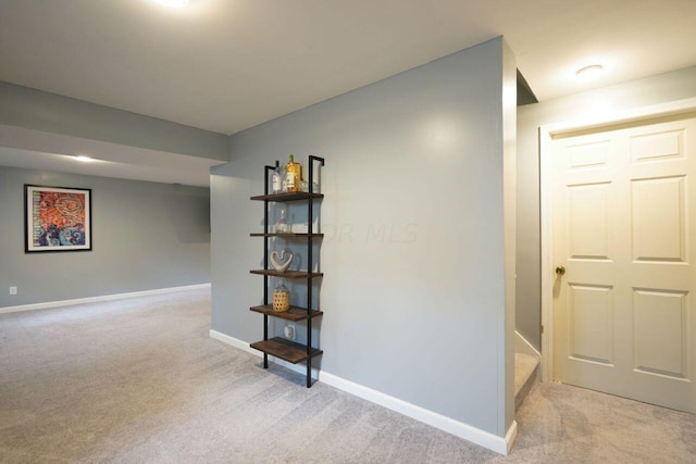 basement featuring light colored carpet