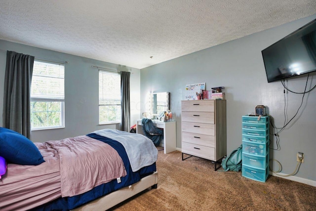 bedroom with a textured ceiling and carpet