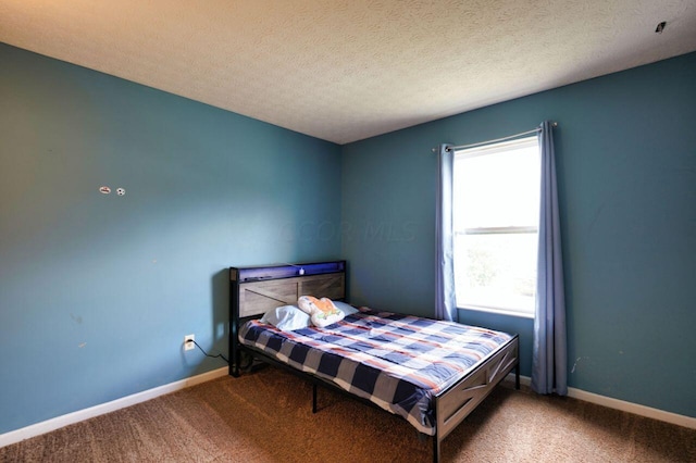 carpeted bedroom featuring a textured ceiling