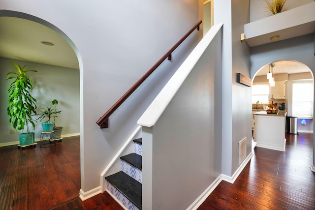 staircase with hardwood / wood-style floors