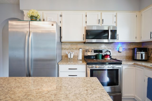 kitchen with stainless steel appliances and white cabinetry