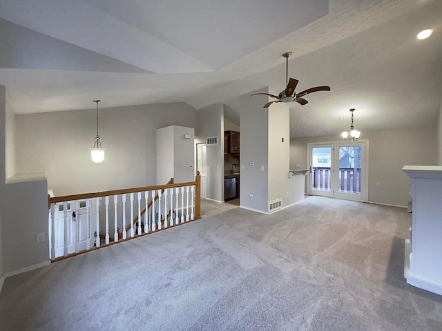 unfurnished room with light carpet, ceiling fan with notable chandelier, and lofted ceiling