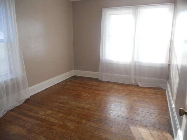 spare room featuring dark hardwood / wood-style floors