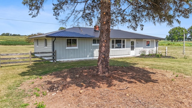 back of house with a lawn