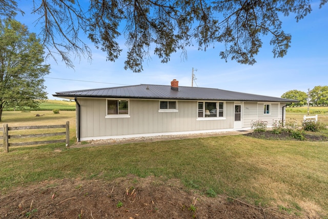 rear view of property featuring a yard