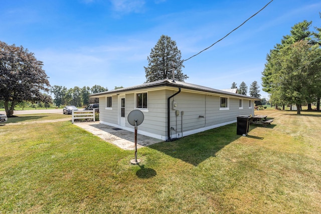 view of property exterior with a lawn