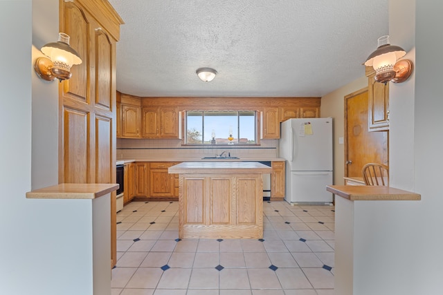 kitchen with a center island, tasteful backsplash, white refrigerator, light brown cabinetry, and light tile patterned flooring