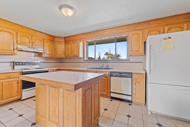 kitchen with tile countertops, a center island, white appliances, decorative backsplash, and a textured ceiling