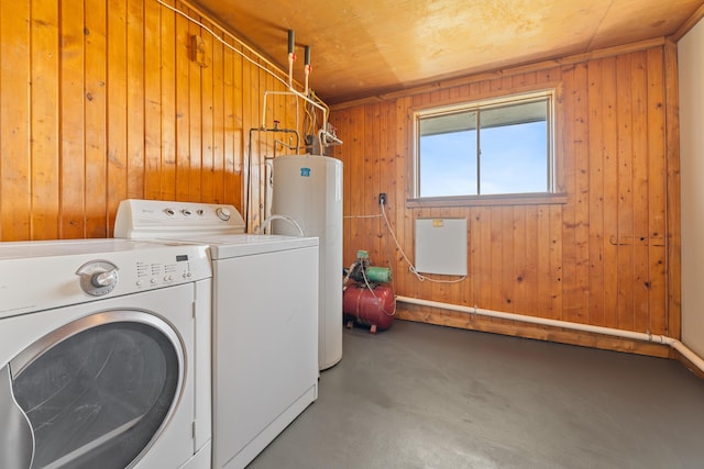 clothes washing area featuring separate washer and dryer, wood ceiling, wooden walls, and water heater