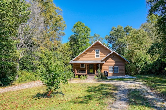 log cabin featuring a front lawn and a porch