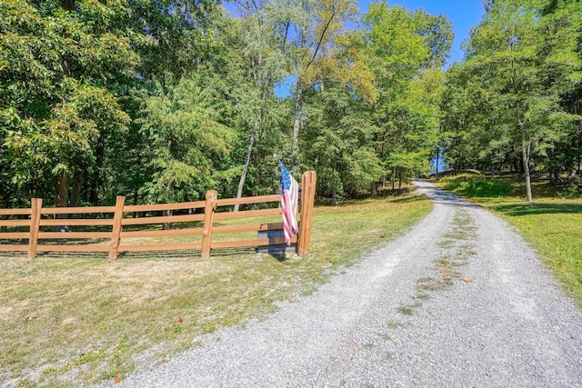 view of gate with a yard