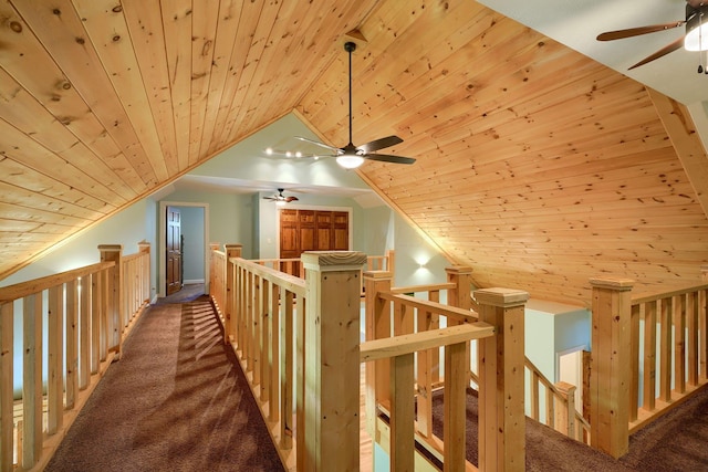 hall featuring carpet floors, vaulted ceiling, and wood ceiling