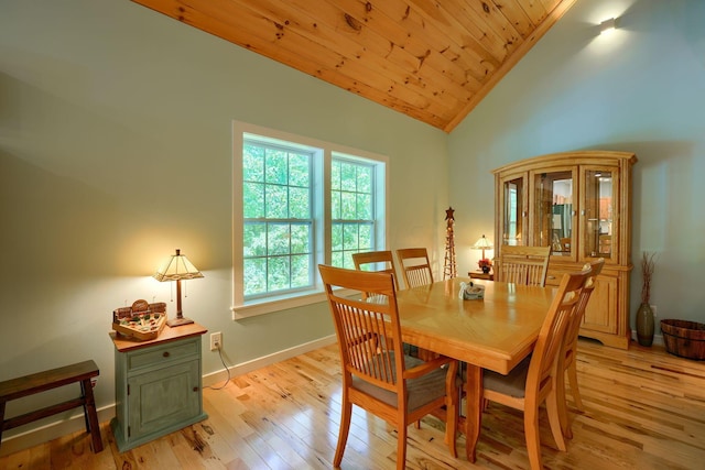 dining area with wooden ceiling, light wood-type flooring, and vaulted ceiling