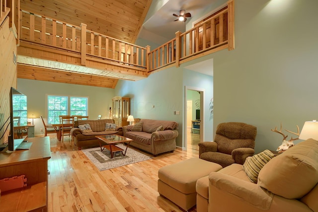 living room with ceiling fan, high vaulted ceiling, wooden ceiling, and light wood-type flooring