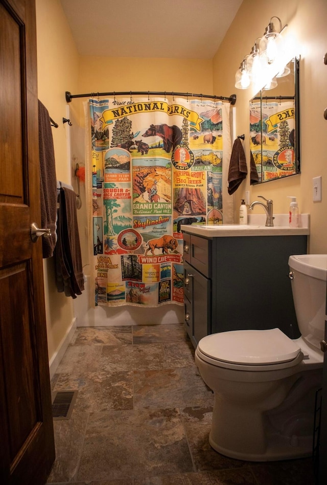 bathroom with vanity, toilet, and curtained shower