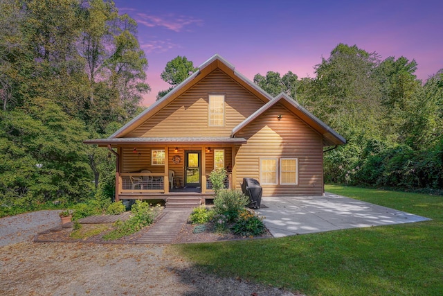 view of front of house featuring a lawn and a porch