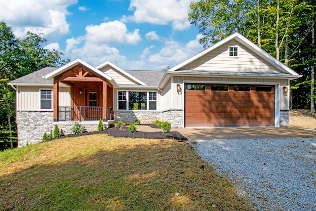 craftsman inspired home featuring board and batten siding, gravel driveway, an attached garage, and stone siding