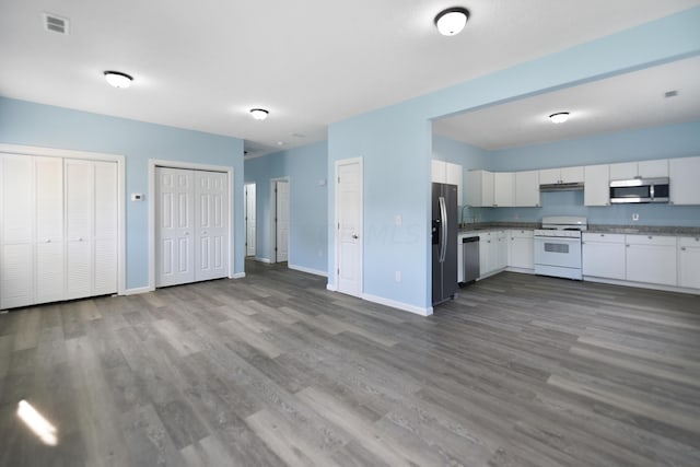 kitchen with white cabinetry, stainless steel appliances, and light hardwood / wood-style flooring