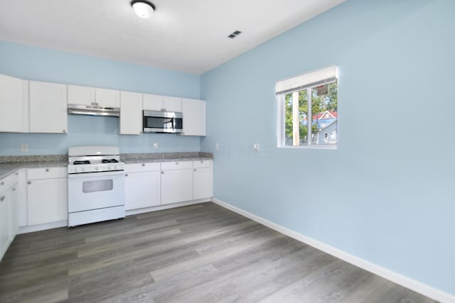 kitchen featuring wood-type flooring, white cabinetry, and gas range gas stove