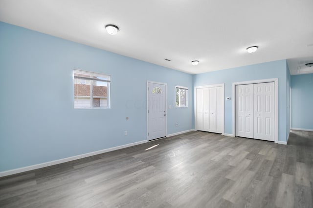 interior space with hardwood / wood-style flooring and multiple closets