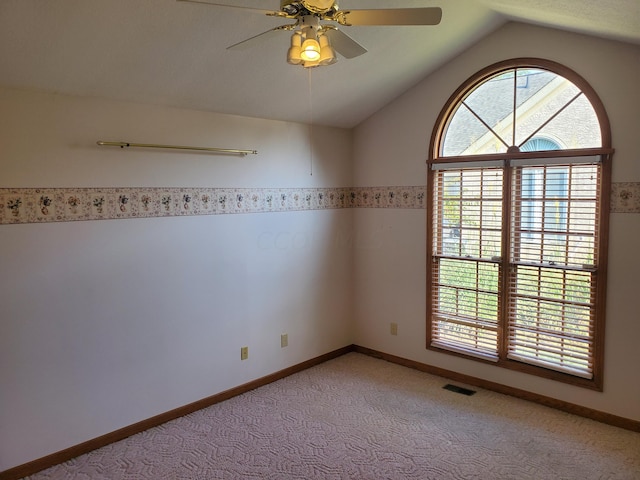 carpeted empty room featuring ceiling fan and lofted ceiling