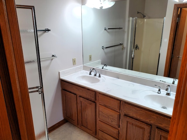 bathroom with vanity and a shower with shower door