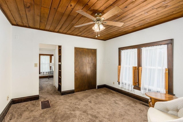 unfurnished bedroom featuring ceiling fan, carpet, and wooden ceiling