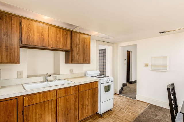 kitchen featuring sink, light parquet floors, and white range