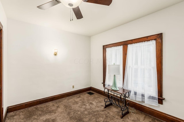 carpeted spare room with ceiling fan